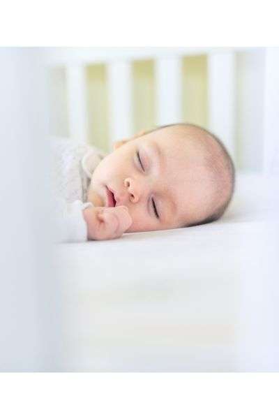 Infant sleeping in a crib.