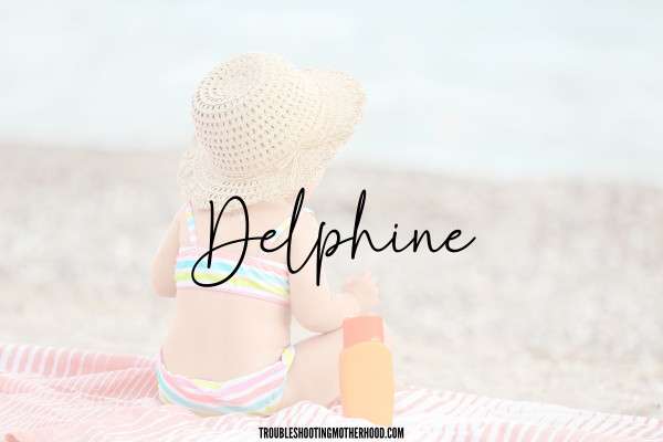 Beachy Names for Girls. Image of baby girl on beach, with the name "Delphine" in text. 