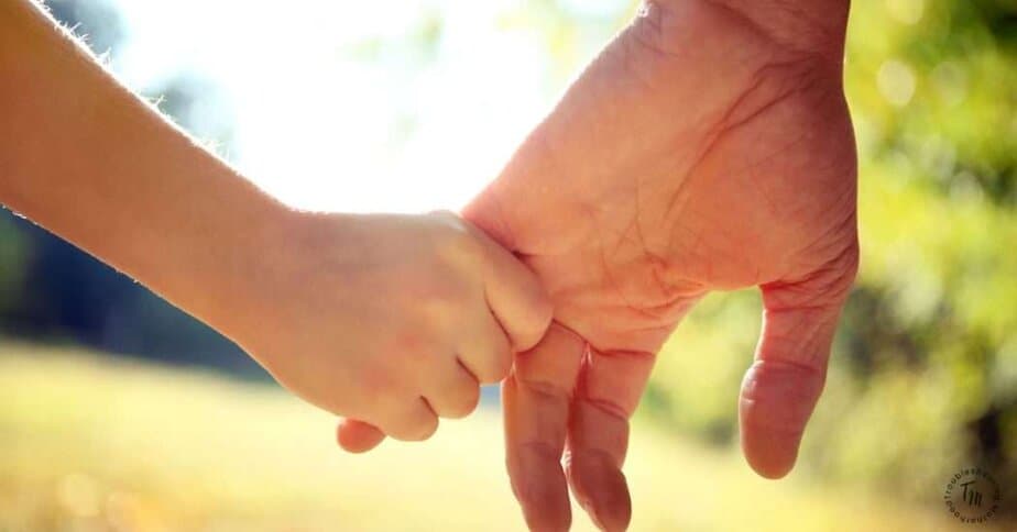 Life skills to teach your kids today. Image of parent and child holding hands.