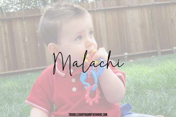 Biblical boy name. Image of toddler boy sitting in the grass, with a teething toy. Text overlay of the name: Malachi, a baby name from the bible.