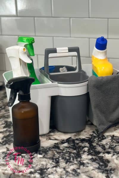 cleaning supplies in a caddy on a kitchen counter. What to clean first when everything is a mess.