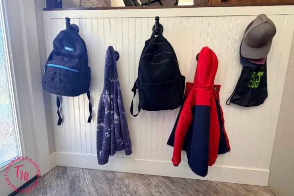 The messy house cycle. Image of entry with wall hooks for jackets and backpacks.