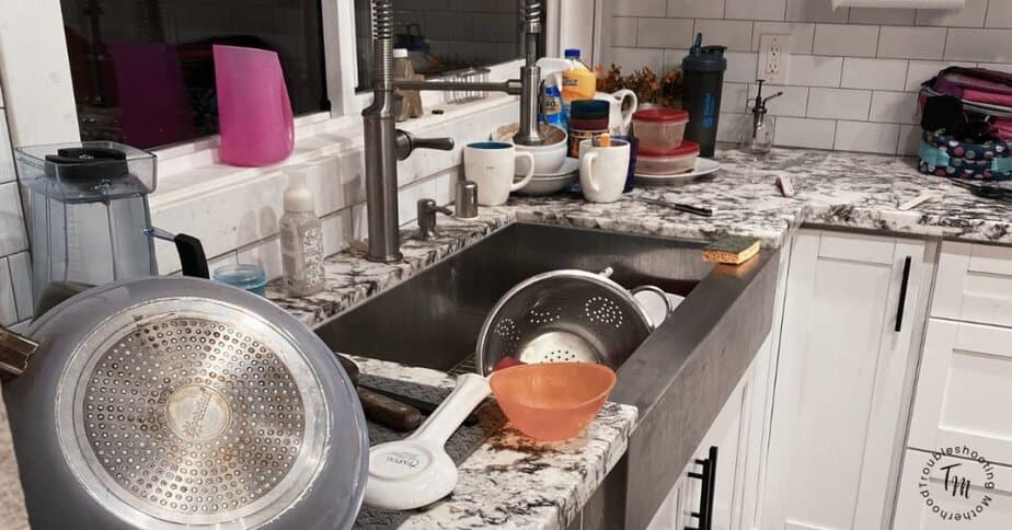 overwhelmed mom’s messy kitchen with dishes and clutter. What to clean when you don't know where to start. 