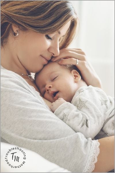 How to clean when your baby only contact naps. Image of baby sleeping on mom.