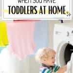 How to clean when you have toddlers at home. image of toddler taking clothes out of the dryer.